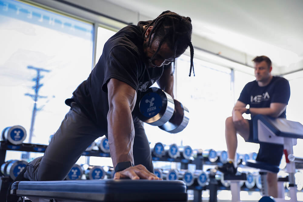 a man working out with dumbbells in a gym