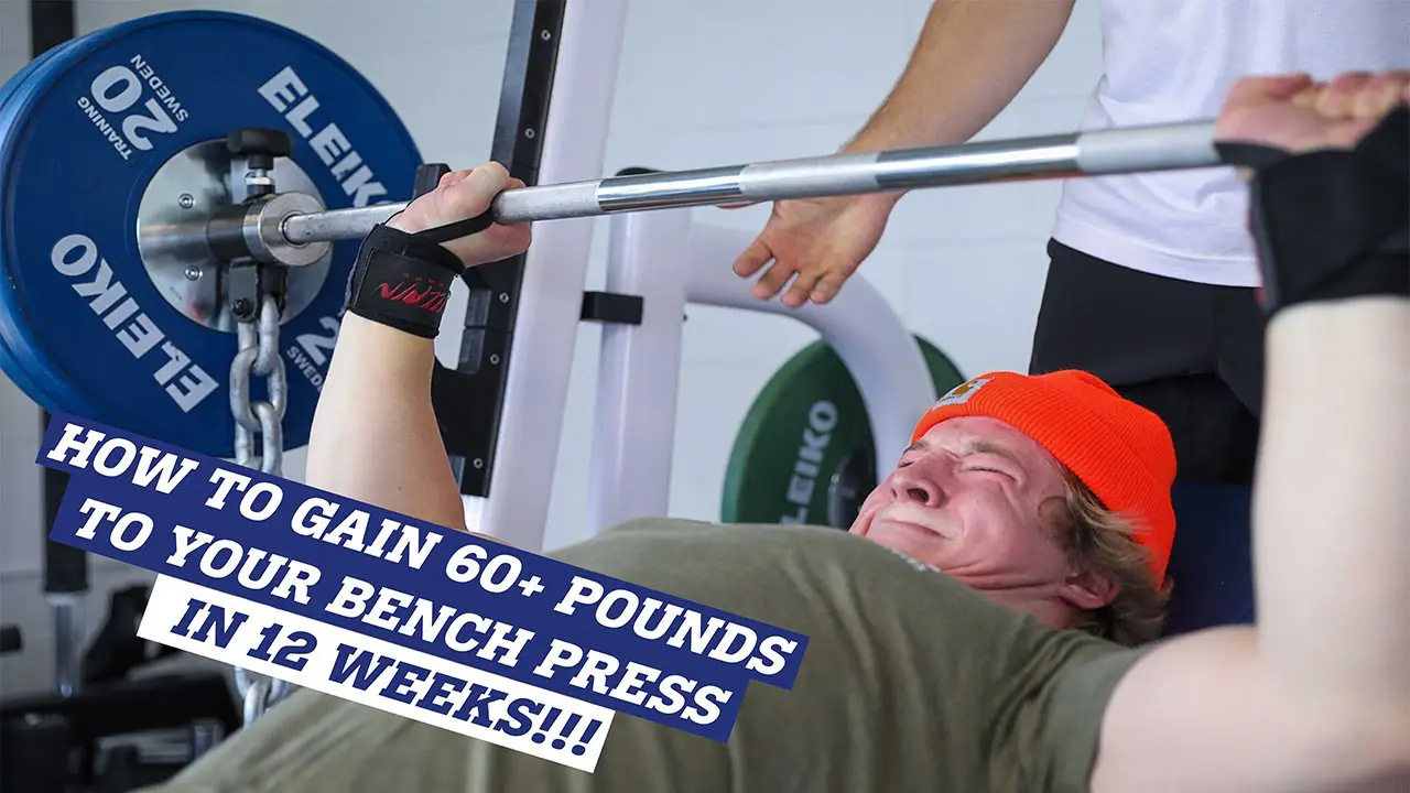 a man in a red hat is lifting a bench press.