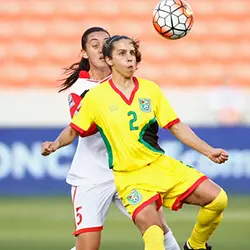 two women playing soccer in the stands.