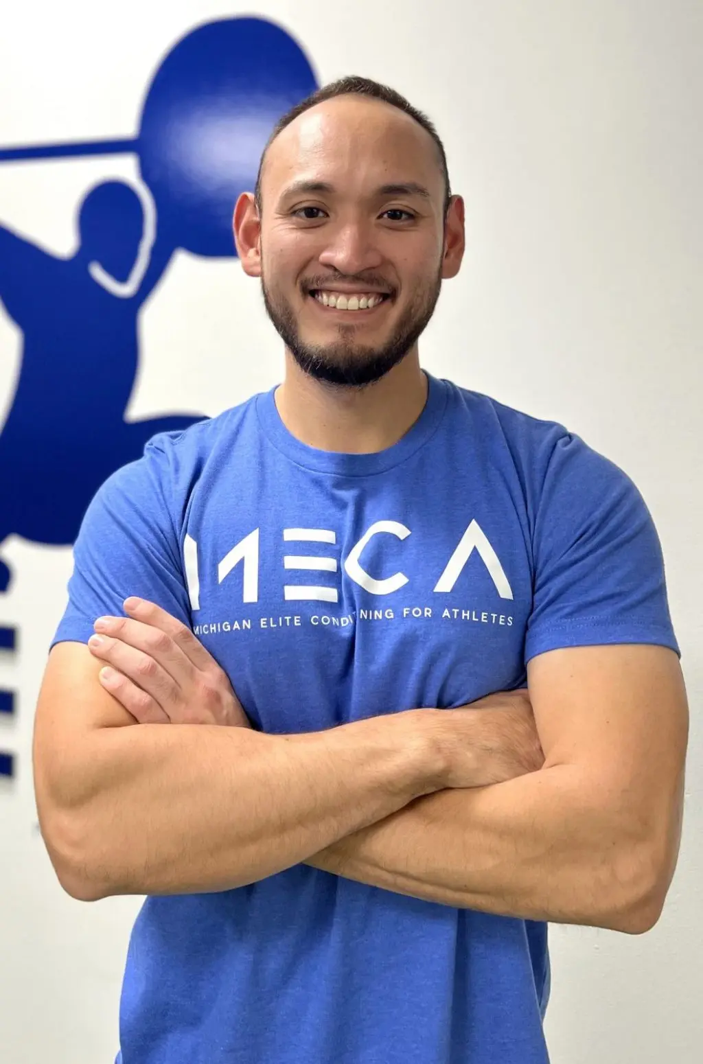 a man in a blue shirt smiling