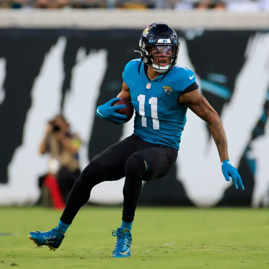 Marvin Jones Jacksonville jaguars wide receiver runs with the ball during the first half of an nfl football game.