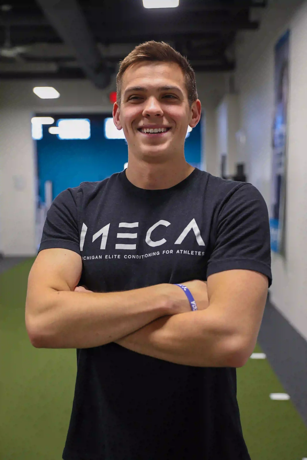 a man in a gym with his arms crossed at MECA gym