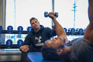 A man works out with a personal trainer at MECA