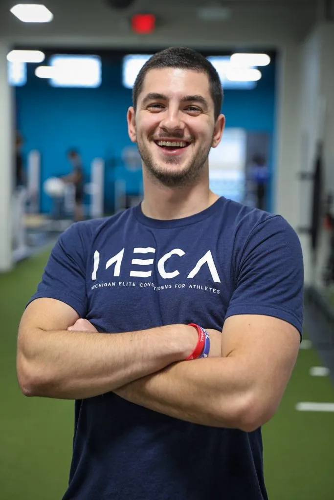 a man in a blue shirt smiling