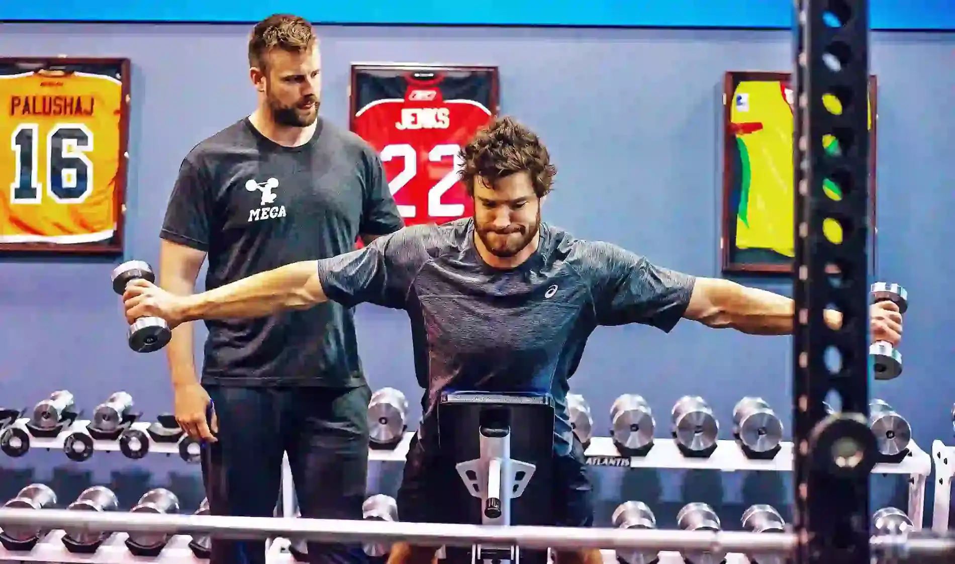 A man works out with a personal trainer at the MECA gym.