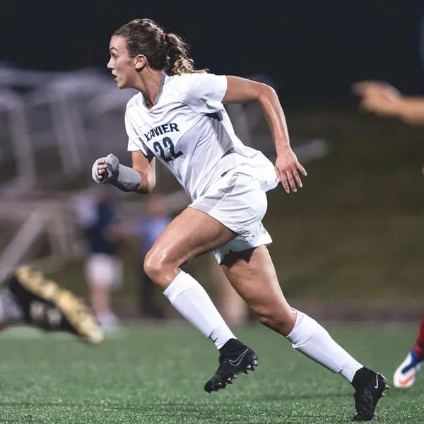 A picture of Sydney who a senior soccer player while playing soccer.