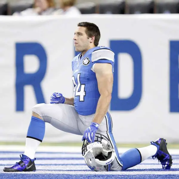 A picture of detroit lions wide receiver zach-zenner kneels on the field before the game against the dallas cowboys at ford field.