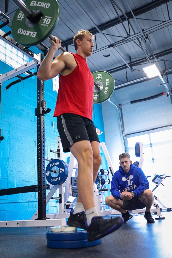 Caden Ebeling a Pro Basketball player doing step ups as he is getting trained by a coach from MECA