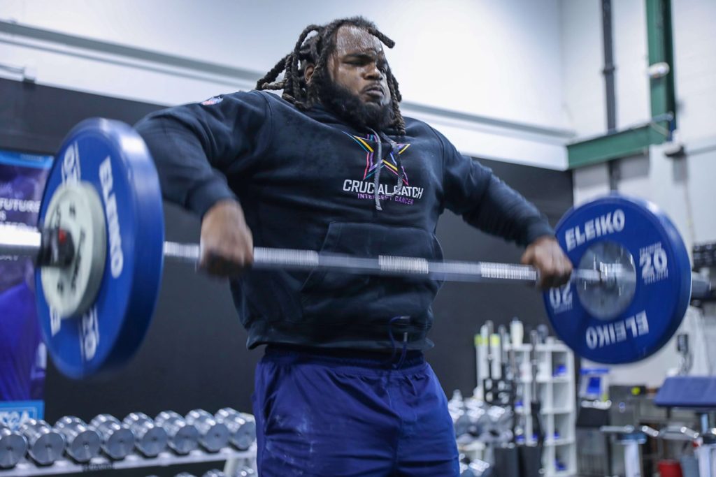 Mazi Smith of the Dallas Cowboys lifting a heavy barbell at MECA