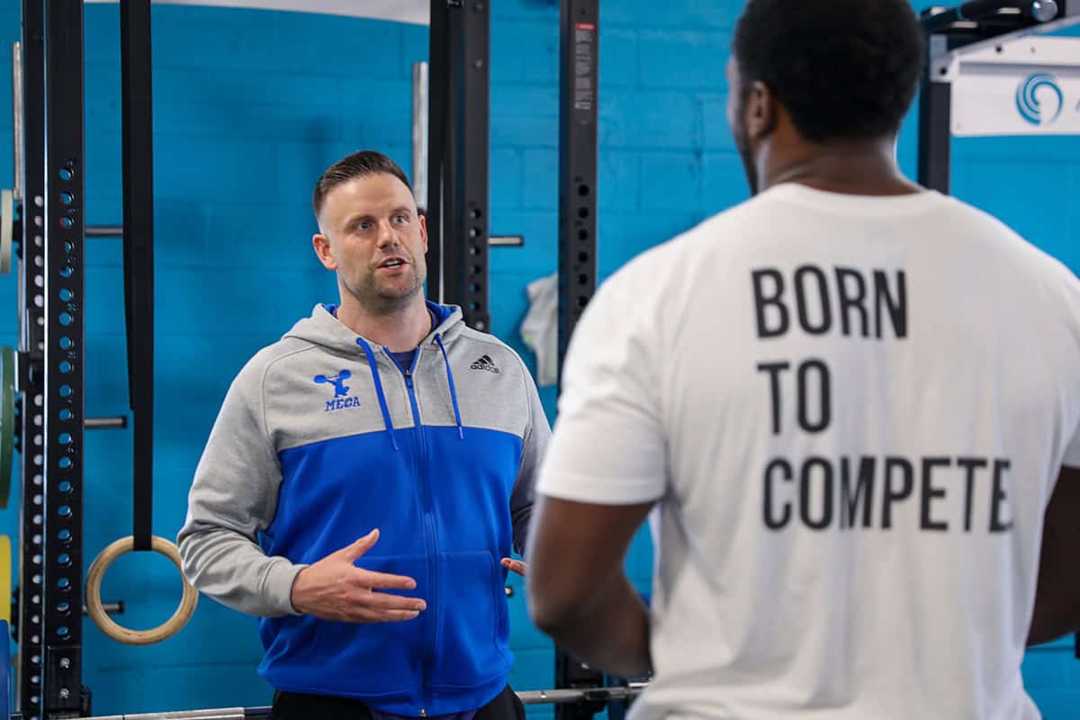 David Lawrence Personal Trainer standing in front of NFL player