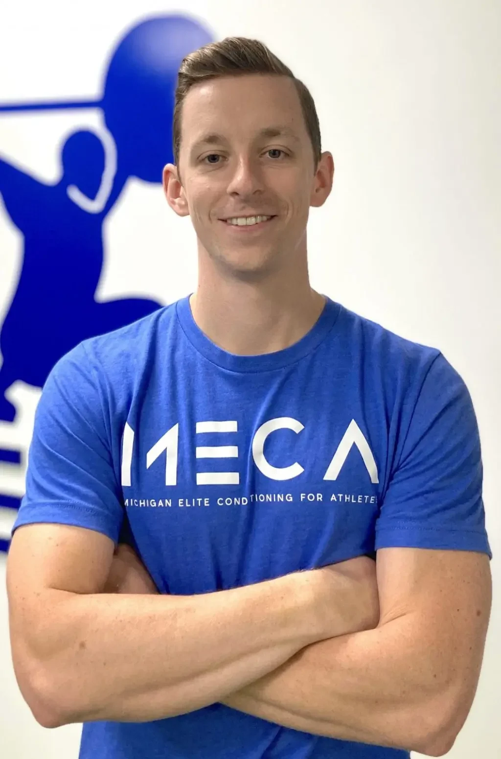Alex who is a training coach at MECA is smiling at camera