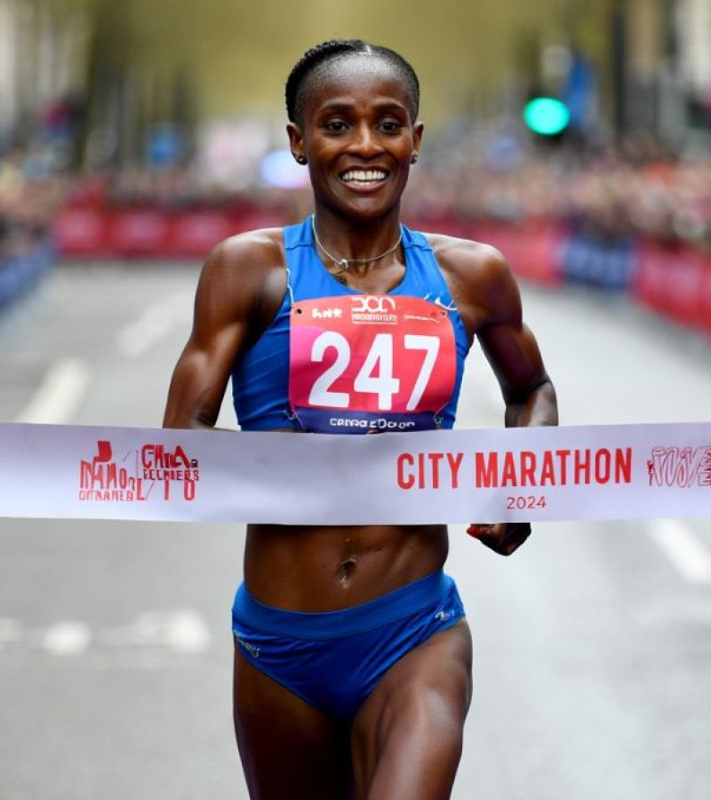 Muscular female marathon runner at finish